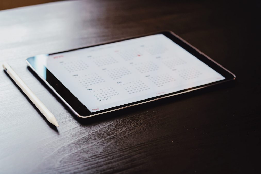 ipad on a desk showing the calendar for planning social media posts